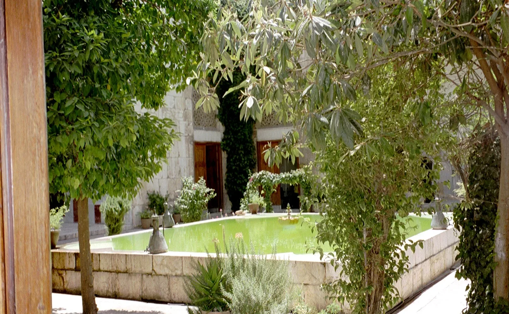 The pool and planted courtyard of the Bimaristan of Nur al-Din in Old Damascus, seen through a doorway
