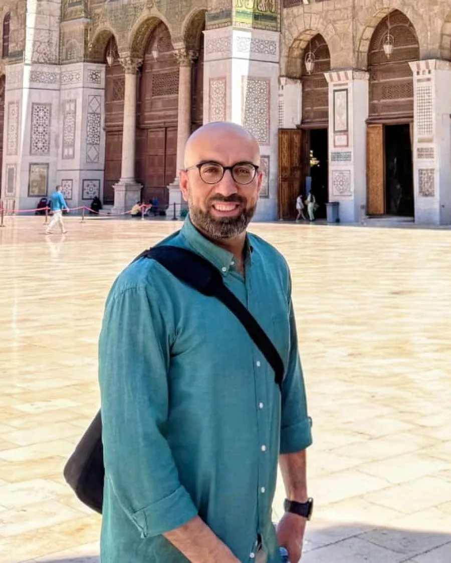 Amir, the founder and guide of Syria Spiritual Tours, standing in the courtyard of the Umayyad Mosque in Damascus