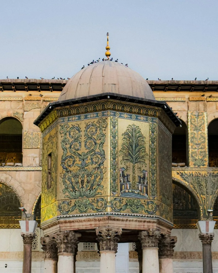 The gold mosaic Dome of the Treasury standing on Corinthian columns in the courtyard of the Umayyad Mosque