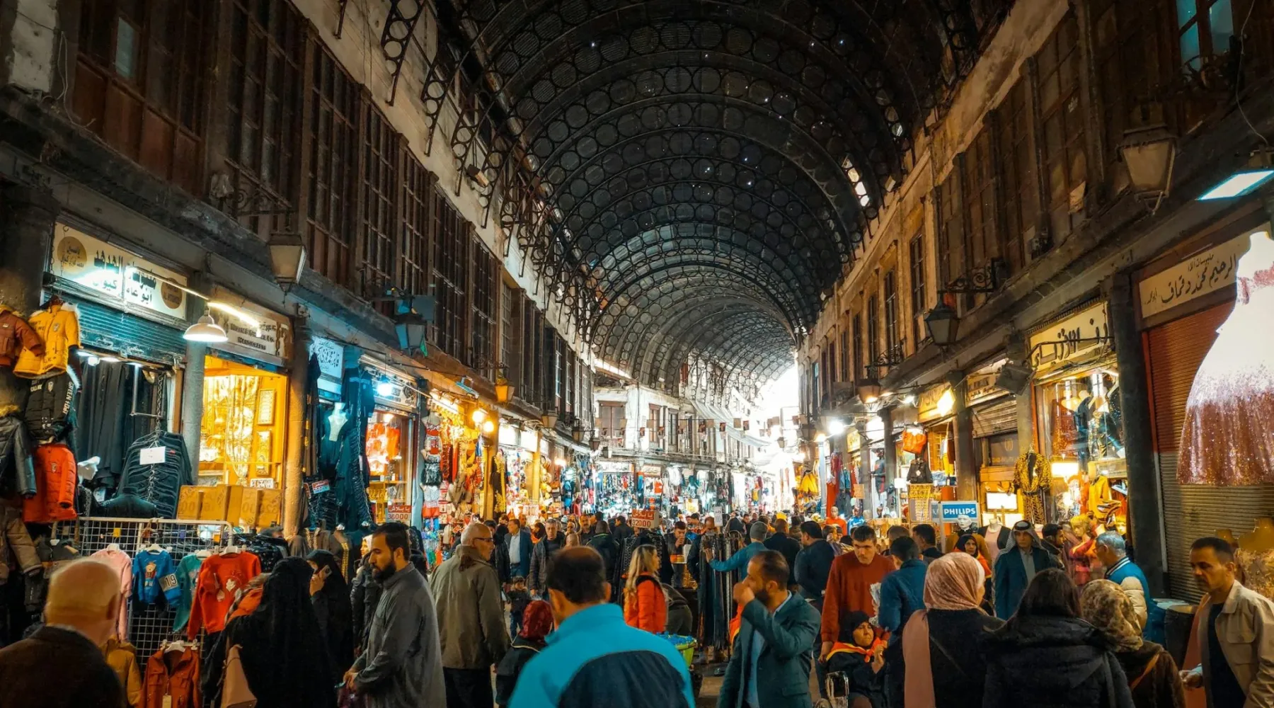 Shoppers beneath the arched iron roof of Souk al-Hamidiyah in Damascus