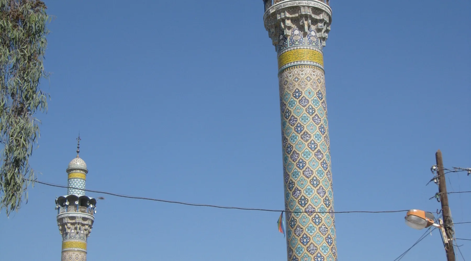 The two tiled minarets and gold dome of the shrine of Sayyida Zainab south of Damascus