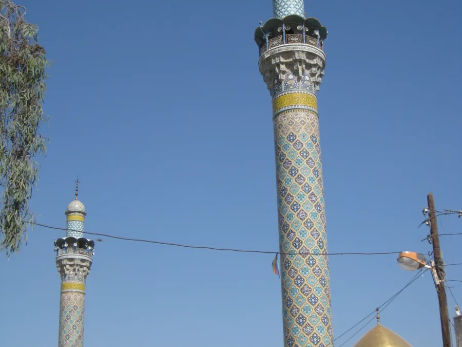 The two tiled minarets and gold dome of the shrine of Sayyida Zainab south of Damascus